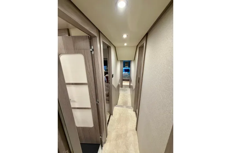 Slide: The Image of Interior hallway of 2020 Azimut Magellano 66 yacht, featuring modern design and lighting. - 73