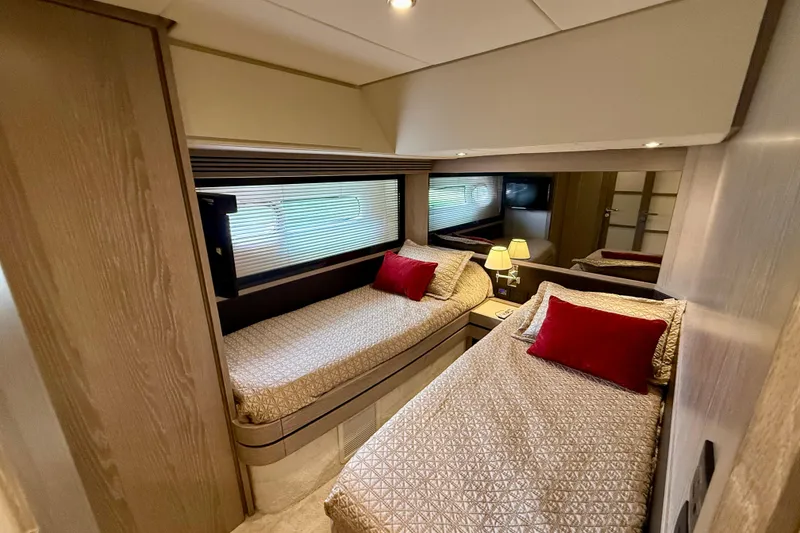 Slide: The Image of Luxurious twin cabin in 2020 Azimut Magellano 66 yacht with elegant decor and red accents. - 74