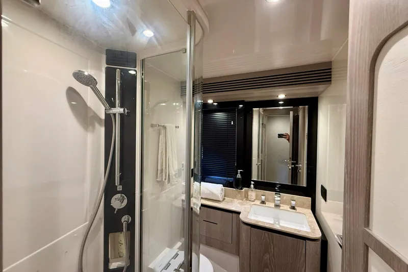 Slide: The Image of Luxurious bathroom interior of 2020 Azimut Magellano 66 yacht, featuring modern fixtures and elegant design. - 79