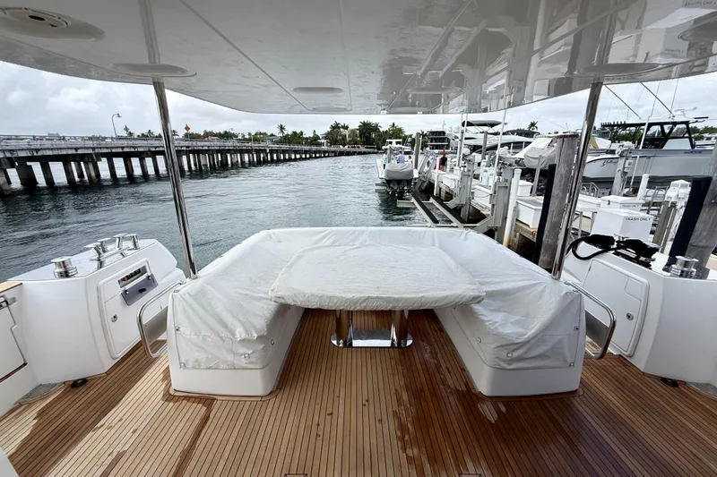 Slide: The Image of Azimut Magellano 66 yacht deck with covered seating area, docked at marina. - 8