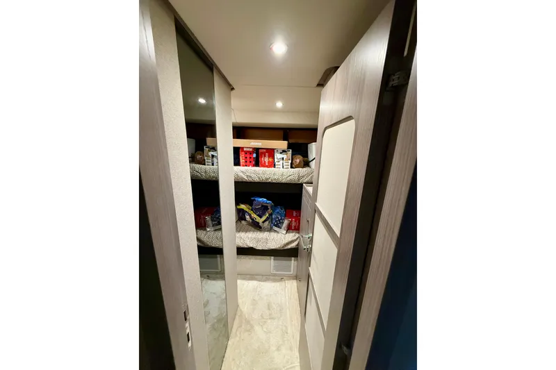 Slide: The Image of Interior view of 2020 Azimut Magellano 66 yacht with storage shelves and modern lighting. - 80