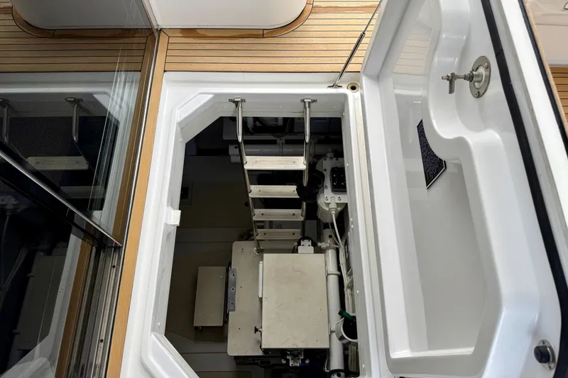 Slide: The Image of Engine room access hatch on 2020 Azimut Magellano 66 yacht, featuring a ladder and mechanical components. - 81