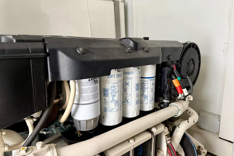 Slide: The Image of Engine components of a 2020 Azimut Magellano 66 yacht, featuring filters and wiring. - 84