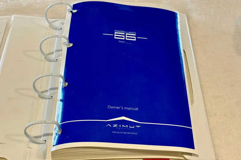 Slide: The Image of Owner's manual for 2020 Azimut Magellano 66 yacht, blue cover in binder. - 95