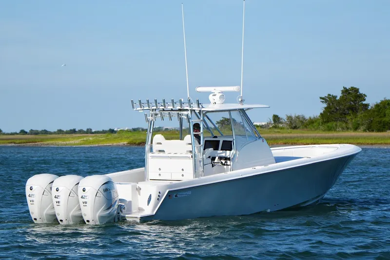 Slide: The Image of 2021 Contender 39 Fisharound boat with triple Yamaha engines on open water. - 10