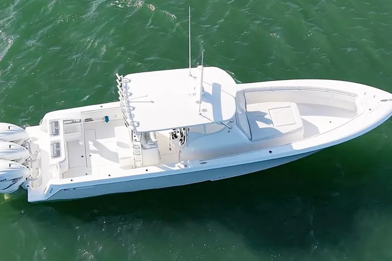 Slide: The Image of 2021 Contender 39 Fisharound boat on water, aerial view, triple outboard engines. - 12