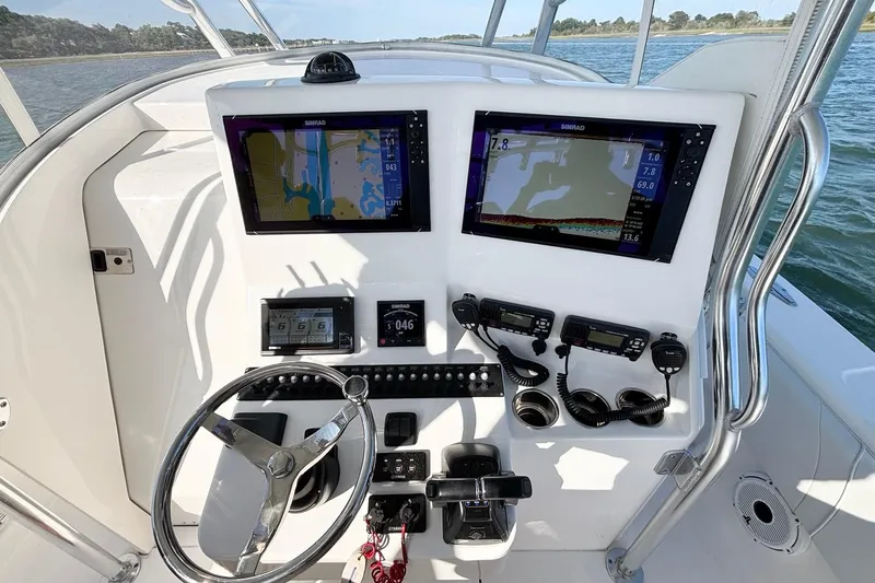 Slide: The Image of Helm of 2021 Contender 39 Fisharound with dual Simrad displays and navigation controls. - 13