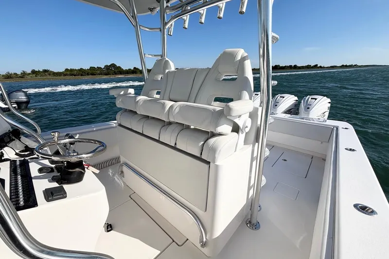 Slide: The Image of 2021 Contender 39 Fisharound boat interior with white seating and steering wheel on open water. - 14