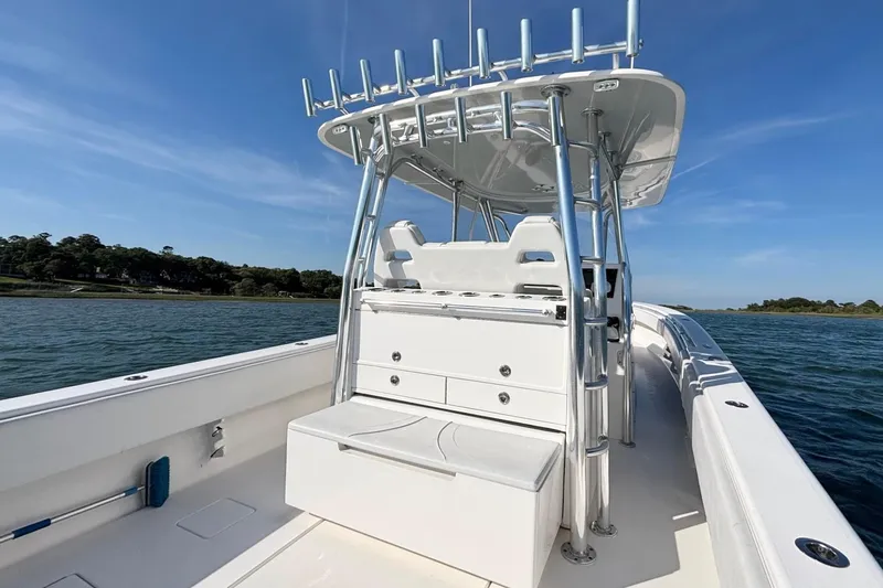Slide: The Image of 2021 Contender 39 Fisharound boat on water, featuring sleek design and spacious deck. - 15
