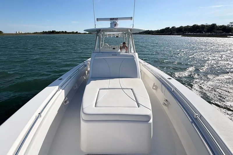Slide: The Image of 2021 Contender 39 Fisharound boat cruising on a sunny day, featuring spacious deck seating. - 16