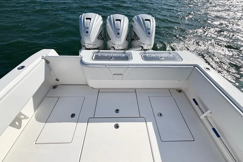 Slide: The Image of 2021 Contender 39 Fisharound boat with triple outboard engines on open water. - 17