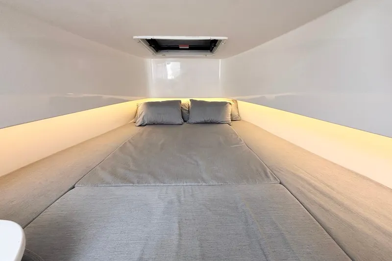 Slide: The Image of Interior cabin of 2021 Contender 39 Fisharound with cozy bedding and ambient lighting. - 20