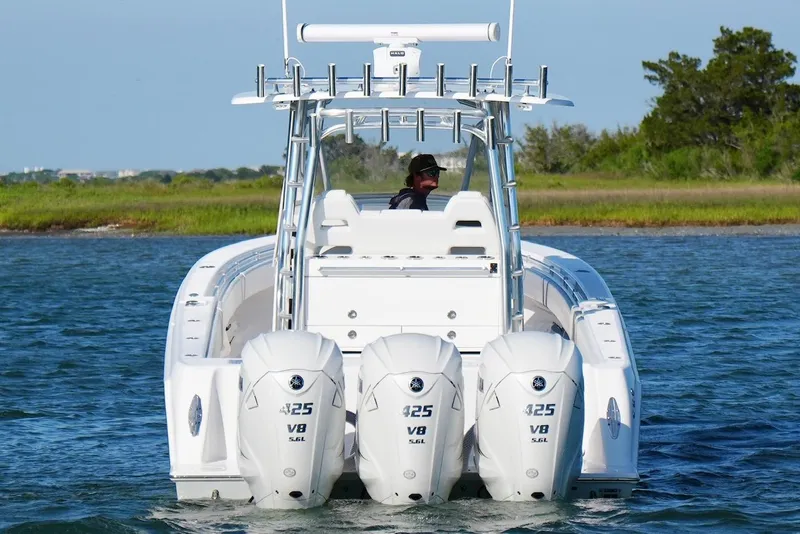 Slide: The Image of 2021 Contender 39 Fisharound boat with triple Yamaha 425 V8 engines on water. - 3