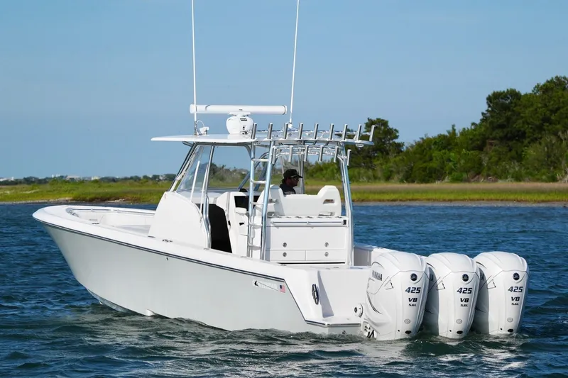 Slide: The Image of 2021 Contender 39 Fisharound boat with triple Yamaha 425 engines on water. - 4