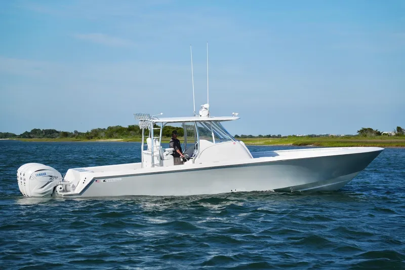 Slide: The Image of 2021 Contender 39 Fisharound boat cruising on open water with Yamaha engines. - 7