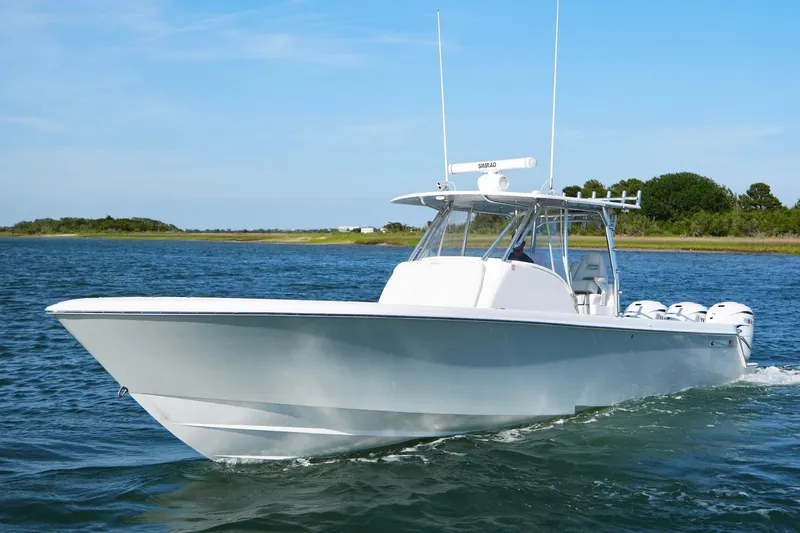 Slide: The Image of 2021 Contender 39 Fisharound boat cruising on a clear blue waterway. - 8
