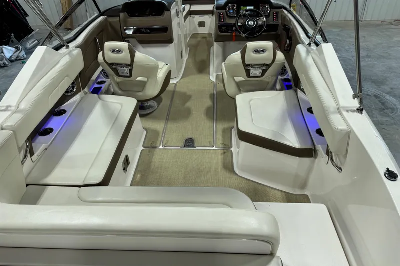 Slide: The Image of 2015 Chaparral 257 SSX boat interior with beige seating and modern dashboard. - 6