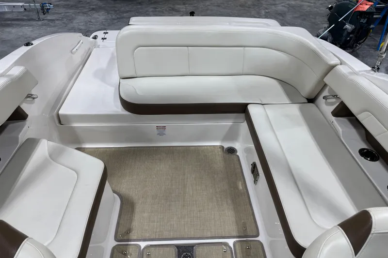 Slide: The Image of 2015 Chaparral 257 SSX boat interior with white and brown seating arrangement. - 7