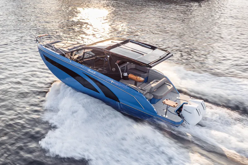 Slide: The Image of A sleek 2027 Hanover 347 Outboard boat cruising on water at sunset. - 12