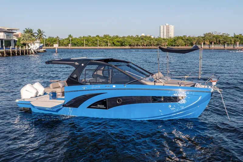 Slide: The Image of 2027 Hanover 347 Outboard boat on water, sleek blue design, sunny day. - 14
