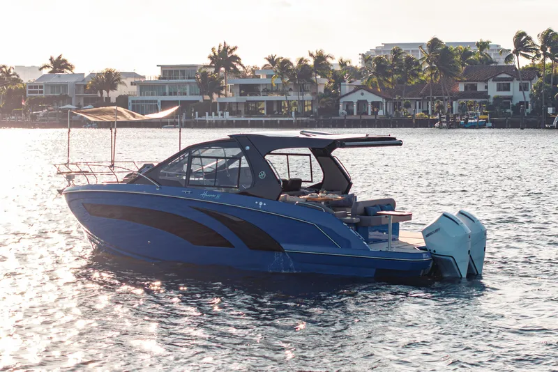 Slide: The Image of A sleek 2027 Hanover 347 Outboard boat on water near luxury waterfront homes. - 16