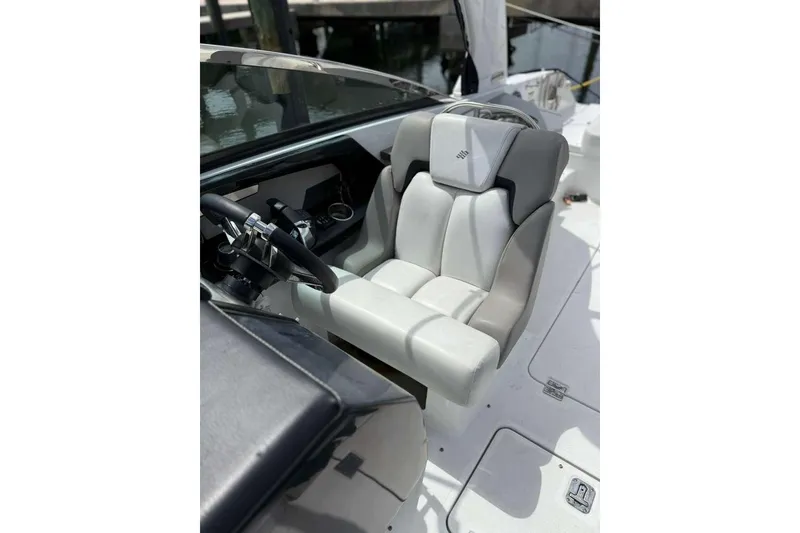 Slide: The Image of Captain's seat of 2022 Four Winns H290 OB boat, featuring sleek design and modern controls. - 10
