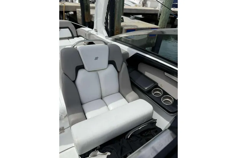 Slide: The Image of 2022 Four Winns H290 OB boat interior with plush seating and cup holders. - 11