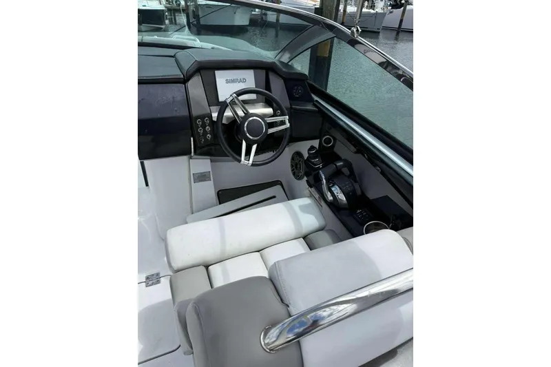 Slide: The Image of 2022 Four Winns H290 OB boat interior with steering wheel and control panel. - 13