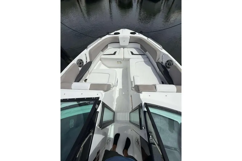 Slide: The Image of 2022 Four Winns H290 OB boat interior with spacious seating and open deck design. - 16