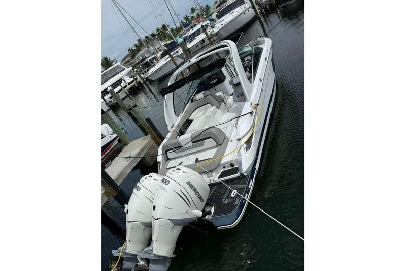 Slide: The Image of 2022 Four Winns H290 OB boat docked with twin Mercury outboard engines. - 3