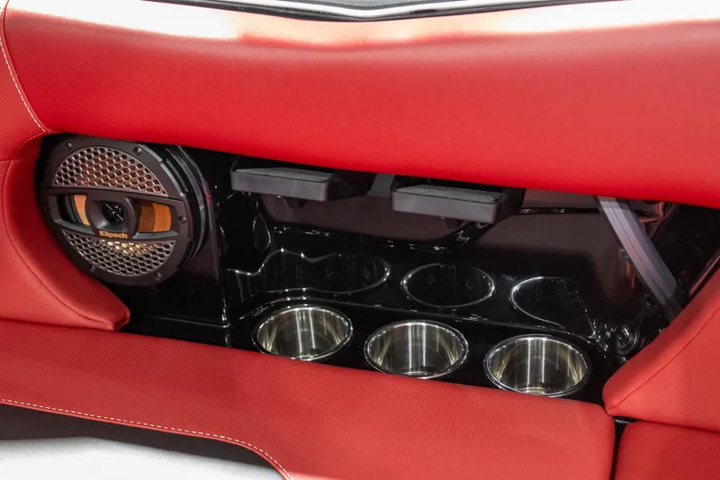 Slide: The Image of 2024 MasterCraft NXT23 interior with speaker and cup holders. - 12