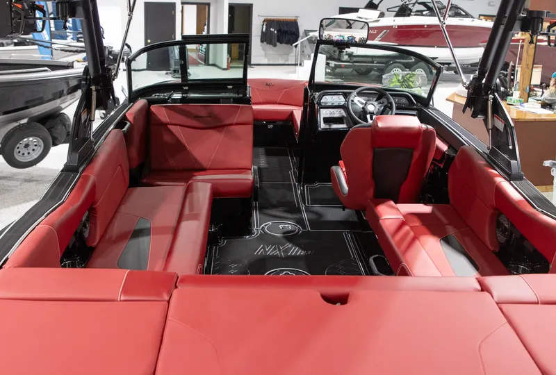 Slide: The Image of Interior of 2024 MasterCraft NXT23 with red leather seating. - 6