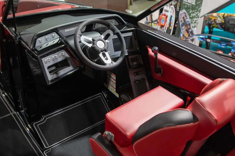 Slide: The Image of 2024 MasterCraft NXT23 interior with red seat and steering wheel. - 7