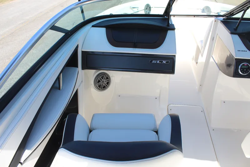 Slide: The Image of Interior of a 2014 Sea Ray SLX 230 boat with seating and dashboard. - 12
