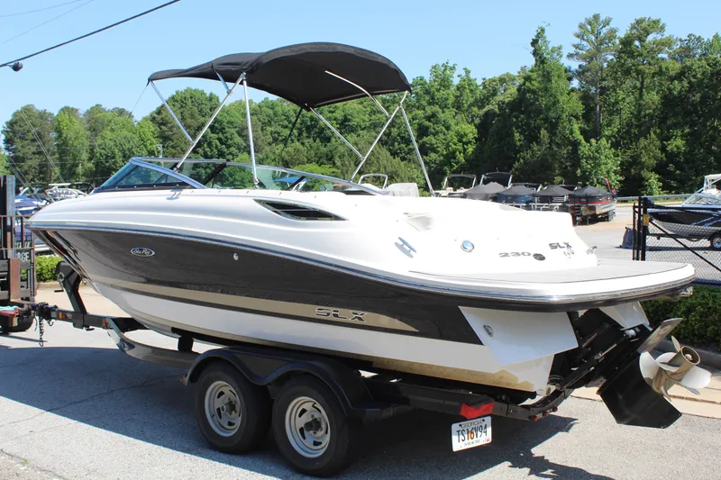 Slide: The Image of 2014 Sea Ray SLX 230 boat on trailer outdoors. - 3