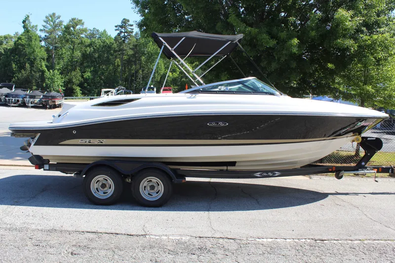 Slide: The Image of 2014 Sea Ray SLX 230 boat on trailer outdoors. - 6