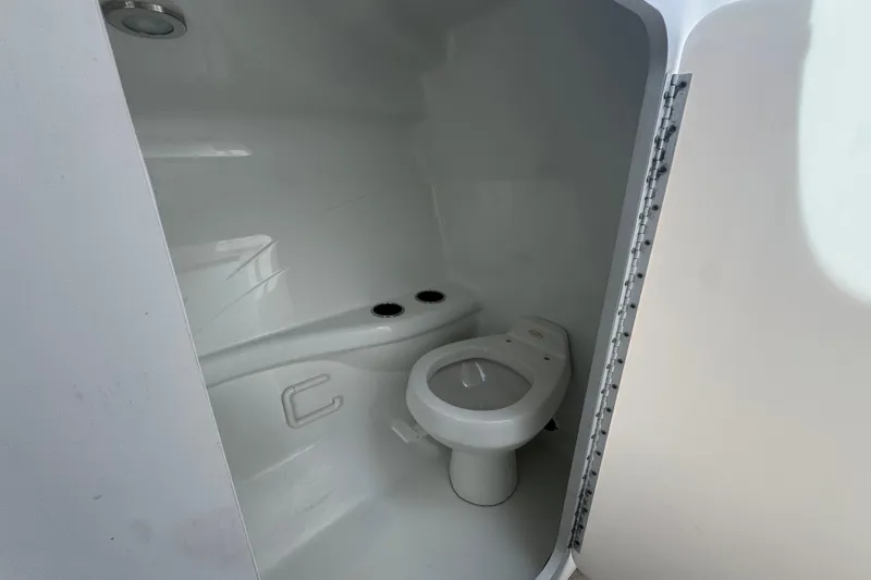 Slide: The Image of 2006 Formula 382 FASTech boat bathroom with white interior and compact toilet. - 10