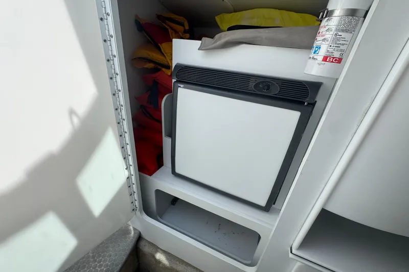 Slide: The Image of 2006 Formula 382 FASTech cabin with life jackets, mini fridge, and fire extinguisher. - 11
