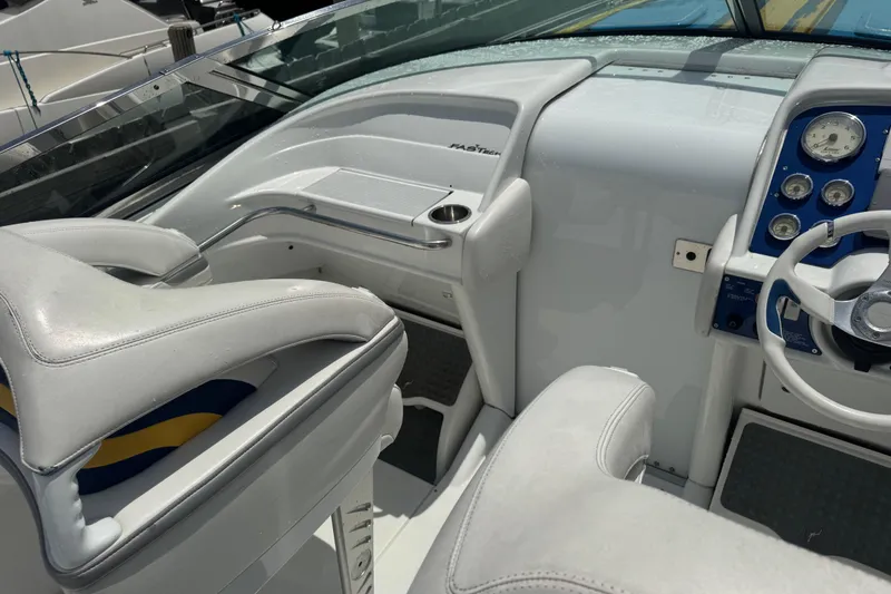 Slide: The Image of 2006 Formula 382 FASTech boat cockpit with white seating and control panel. - 5