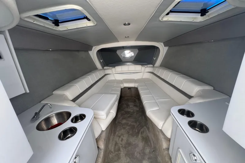 Slide: The Image of Interior of 2006 Formula 382 FASTech boat with white seating and compact kitchenette. - 8