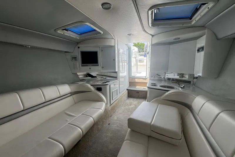 Slide: The Image of Interior of a 2006 Formula 382 FASTech boat with white seating and modern amenities. - 9