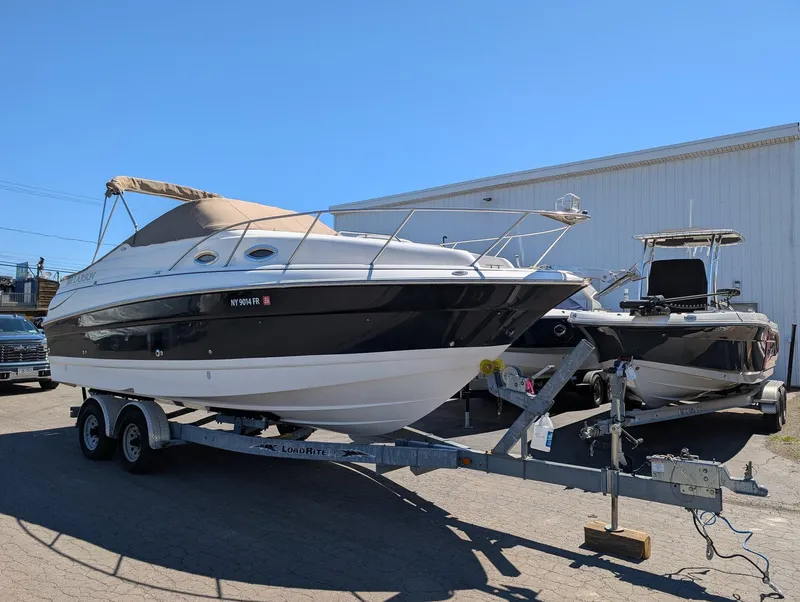 The Image of 2007 Larson Cabrio 240 boat on trailer outdoors. - 1