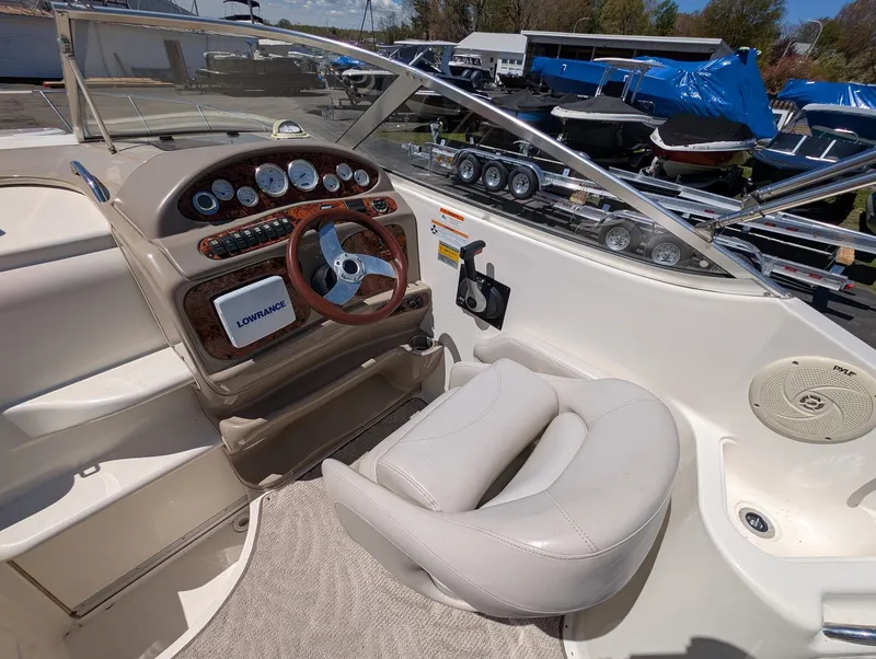 Slide: The Image of Interior of a 2007 Larson Cabrio 240 boat with steering console. - 13