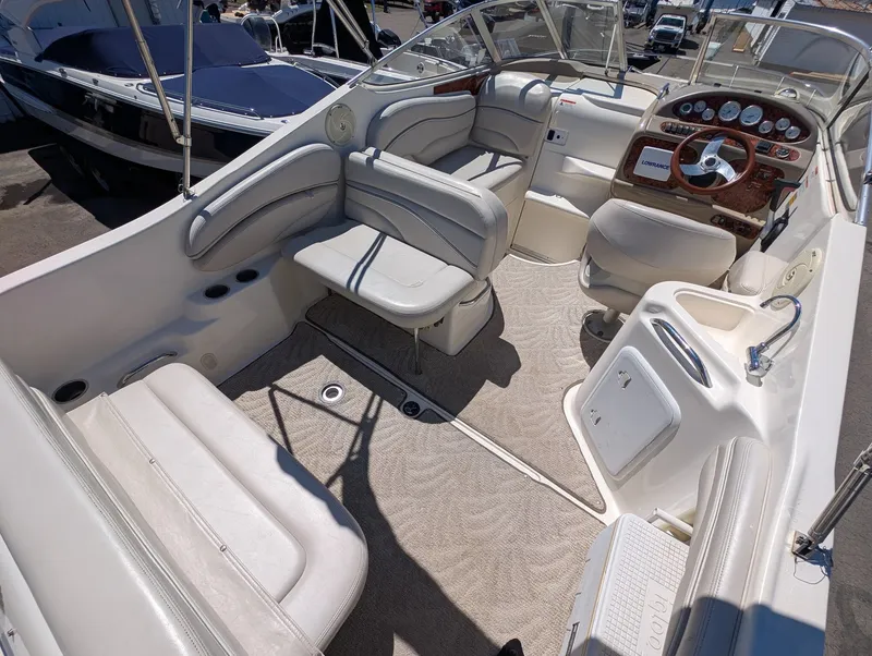 Slide: The Image of Interior of a 2007 Larson Cabrio 240 boat with beige seating. - 16