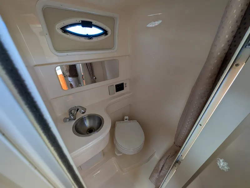 Slide: The Image of Interior of 2007 Larson Cabrio 240 with sink and toilet. - 23