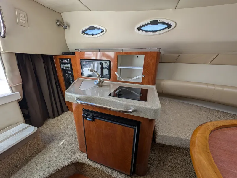Slide: The Image of Interior of 2007 Larson Cabrio 240 yacht featuring kitchenette. - 24