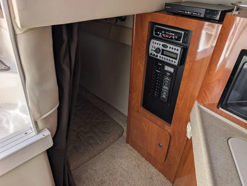 Slide: The Image of Interior of 2007 Larson Cabrio 240 yacht with wood paneling and control panel. - 25