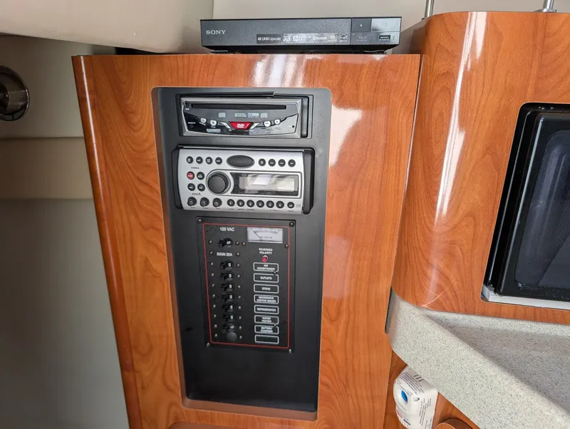 Slide: The Image of 2007 Larson Cabrio 240 interior with wood paneling and control panel. - 26