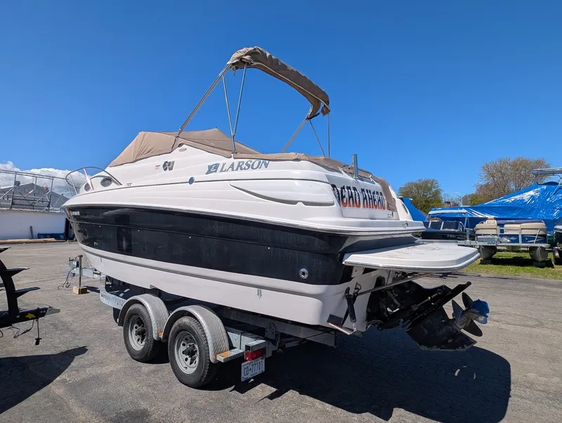 Slide: The Image of 2007 Larson Cabrio 240 boat on trailer, blue sky. - 3