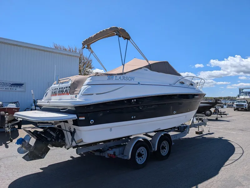 Slide: The Image of 2007 Larson Cabrio 240 boat on trailer in sunny weather. - 4